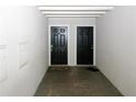 A pair of black doors with mats provide a secure entrance into the units at 1150 Collier Rd # K3, Atlanta, GA 30318