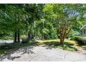 Spacious driveway with mature trees, leading to a charming home at 3754 Wyntuck Nw Cir, Kennesaw, GA 30152