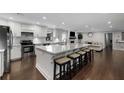 Bright kitchen with white cabinets, stainless appliances, and a large island with seating at 3844 Sw Saddle Ridge Dr, Snellville, GA 30039