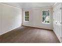 Bedroom featuring neutral carpet, white trim, and ample natural light at 5159 Round Table Dr, Ellenwood, GA 30294