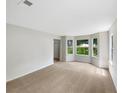 Bright living room featuring large windows and neutral carpet at 5159 Round Table Dr, Ellenwood, GA 30294