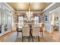 Formal dining room with chandelier, wainscoting, large windows, and neutral color palette at 15 Northwood Ne Ave, Atlanta, GA 30309