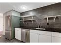 Well-lit kitchen with stainless appliances, dark countertops, and open shelving at 1501 Clairmont Rd # 1522, Decatur, GA 30033