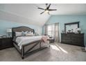Spacious primary bedroom featuring a tray ceiling, ample natural light, and stylish decor at 4271 Keheley Ne Rd, Marietta, GA 30066