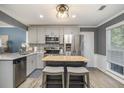 Modern kitchen with stainless steel appliances, gray cabinetry, and a functional center island with seating at 4271 Keheley Ne Rd, Marietta, GA 30066