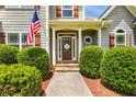 Inviting front entrance with manicured landscaping and an American flag at 168 Gatlin Ridge Run, Dallas, GA 30157