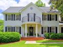 Beautiful two-story home with a balcony, black shutters, and brick front steps at 1808 Jacksons Creek Dr, Marietta, GA 30068