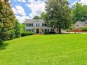 Lovely two-story home with lush green lawn, mature trees, and a front balcony at 1808 Jacksons Creek Dr, Marietta, GA 30068