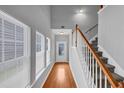 Bright foyer with hardwood floors, staircase, and large windows offering plenty of natural light at 2165 Capella Cir, South Fulton, GA 30331