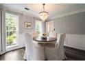 Charming dining room with elegant chandelier and bright natural light at 4188 Kindlewood Ne Ct, Roswell, GA 30075