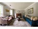 Spacious living room featuring a piano, comfortable seating and natural light at 4188 Kindlewood Ne Ct, Roswell, GA 30075