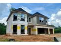 Two-story home under construction with an attached 2-car garage and unfinished yard at 4436 Hosch Reserve Ct, Buford, GA 30519