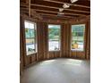 Unfinished room with exposed wood framing, three windows, and natural light at 4436 Hosch Reserve Ct, Buford, GA 30519