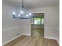 Dining room featuring new flooring and fixture with views of the outside at 1102 Tony Valley Dr, Conyers, GA 30013