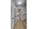 Hallway features neutral walls, wood-look floors and access to upper levels via a carpeted staircase at 1102 Tony Valley Dr, Conyers, GA 30013