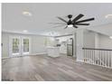 Spacious living room with hardwood floors that connect to a modern kitchen at 2106 Singer Way, Lithonia, GA 30058