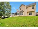 Rear of home with a screened porch and expansive backyard at 2428 Harmony Ridge Ct, Lithonia, GA 30058