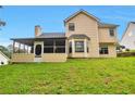 Back view of home with a screened-in porch overlooking the grassy backyard at 2428 Harmony Ridge Ct, Lithonia, GA 30058