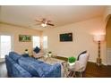 Bright living room features a ceiling fan, and comfortable seating with large windows at 2010 Shortleaf Rd, Fairburn, GA 30213