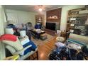 A cozy living room with a brick fireplace and built-in shelving offering storage at 713 Pine Chase Ct, Lawrenceville, GA 30043