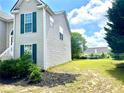 Home's backyard featuring a well-maintained lawn, privacy fence, and landscaping at 203 Galway Ln, Hampton, GA 30228