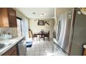 Bright kitchen with stainless steel appliances, dining area, and tile flooring at 5359 Stafford Nw Dr, Lilburn, GA 30047