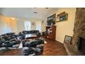 Cozy living room with hardwood floors, stone fireplace, and classic decor at 5359 Stafford Nw Dr, Lilburn, GA 30047
