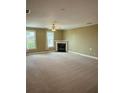 Spacious living room with plush carpeting, a fireplace, and plenty of natural light at 2895 Brandl Cove Ct # 4, Marietta, GA 30067