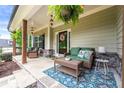 Inviting front porch with stone accents, comfortable seating, and a welcoming entrance, ferns, and hanging lanterns at 510 Black Horse Cir, Canton, GA 30114