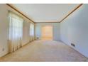 Open living room design with light colored carpet and natural wood trim throughout at 1830 Francis Sw Rd, Conyers, GA 30094