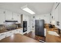 Functional kitchen with white cabinets, wood countertops, stainless steel appliances, and a tiled backsplash at 4624 Stonehenge Dr, Atlanta, GA 30360