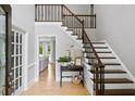 Light-filled foyer with hardwood floors and a staircase with iron railings at 5286 Wild Indigo Nw Way, Acworth, GA 30102