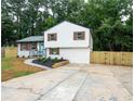 Charming two-story home featuring a bright blue front door, fresh landscaping, and a newly paved driveway at 6050 Randy Ln, Ellenwood, GA 30294