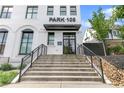 Entrance to the building featuring concrete steps with black metal handrails leading to a glass door at 108 Park Pl # 110, Decatur, GA 30030
