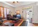 Cozy living room featuring hardwood floors, a large window, and an open doorway at 1454 Beecher Sw St, Atlanta, GA 30310