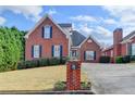 Beautiful brick home with a manicured lawn, blue shutters, and a welcoming driveway at 2324 Blackberry Ct, Snellville, GA 30078
