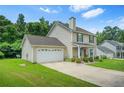 Charming two-story home with an attached garage and driveway at 30 Creek Bottom Dr, Covington, GA 30014