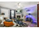 Comfortable living room area with a fireplace, neutral tones, and a ceiling fan at 30 Creek Bottom Dr, Covington, GA 30014