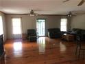 Spacious living room featuring hardwood floors, ceiling fans, and lots of natural light at 4744 Chickasaw Se Way, Acworth, GA 30102