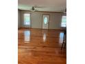 Spacious living room with gleaming hardwood floors and natural light from large windows at 4744 Chickasaw Se Way, Acworth, GA 30102