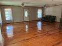 Open living space with wood floors, ceiling fans and two windows for natural light at 4744 Chickasaw Se Way, Acworth, GA 30102