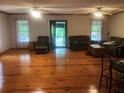 Inviting living room featuring beautiful wood floors, ceiling fans and front door entrance at 4744 Chickasaw Se Way, Acworth, GA 30102