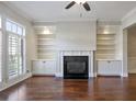 Spacious living room featuring fireplace, custom built-ins and abundant natural light at 1117 Cordia Ave, Atlanta, GA 30318