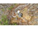 An overhead view captures the home's unique architectural design within a wooded landscape at 1452 Redwine Rd, Fayetteville, GA 30215