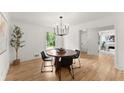 Bright dining room with modern light fixture, hardwood floors, and four chairs at 2855 Lamer Trce, Marietta, GA 30066