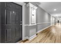 Condo hallway with unit door showing and laminate flooring at 1850 Cotillion Drive # 2118, Dunwoody, GA 30338