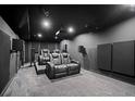 Luxurious home theater with plush seating, projector, and surround sound system for entertainment at 2050 Poplar Ridge Pl, Cumming, GA 30040