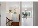 Inviting foyer view with staircase, pendant light, and glimpse of a bright breakfast nook at 2367 Millhaven Se St, Smyrna, GA 30080