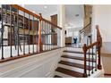 Elegant staircase with wood and wrought iron banister leading to the living area at 2367 Millhaven Se St, Smyrna, GA 30080