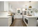 Stylish kitchen with white cabinets, stainless steel appliances, and a large center island with pendant lighting at 3135 Bluebird Ln, Decatur, GA 30032